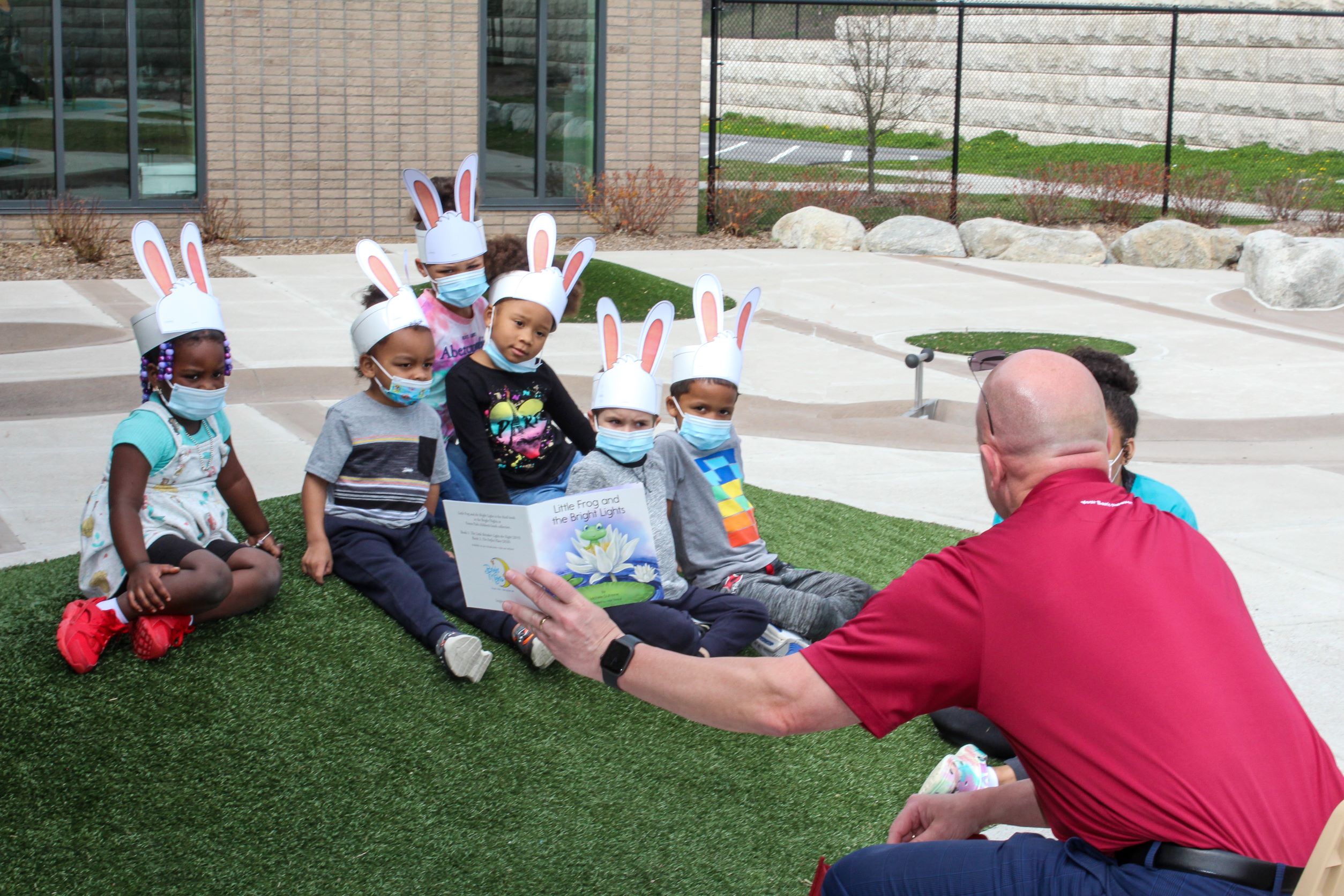 Dan Moriarty, President and CEO of Monson Savings Bank, reads aloud the story of “Little Frog and the Bright Lights” to preschool children at Educare Springfield. A copy of the book and a piggy bank was given to each child.