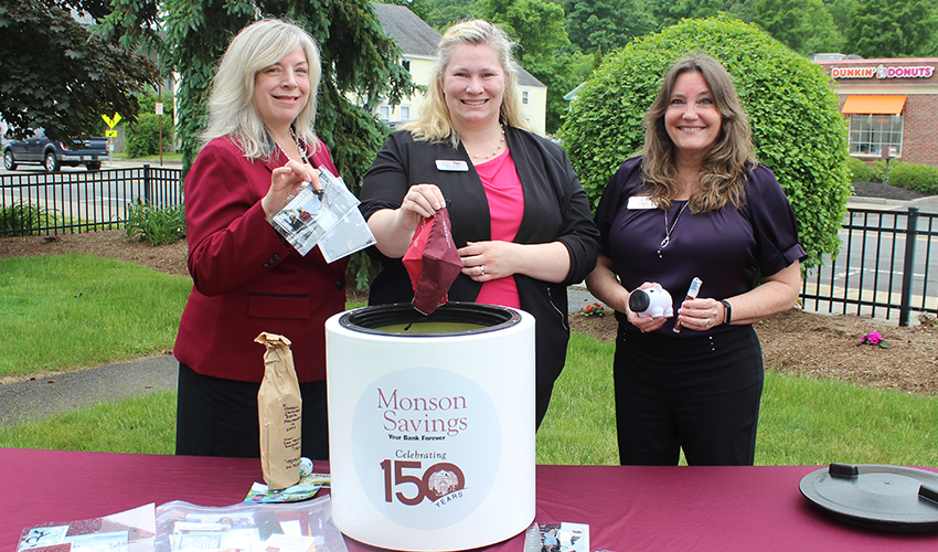 Senior Vice President Dina Merwin, BSA Officer & Compliance Manager Heather Arbour, and Senior Vice President Terri Fox add photos, masks, piggy banks and hand sanitizers to the time capsule.